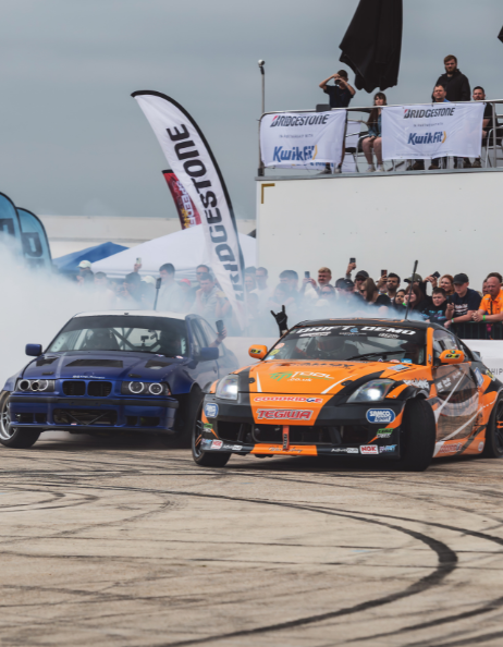 2 Drift cars alongside each other in a live area